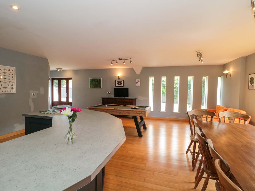 A kitchen with bar counter and dining table at Lady Of Lourdes Whitchurch, Herefordshire
