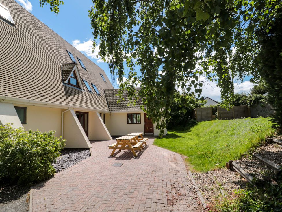 An outdoor area with a patio table and chairs at Lady Of Lourdes in Whitchurch, Herefordshire