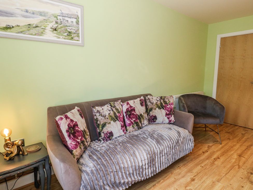 A living room with a sofa and armchair at Rodwell Holt in Weymouth