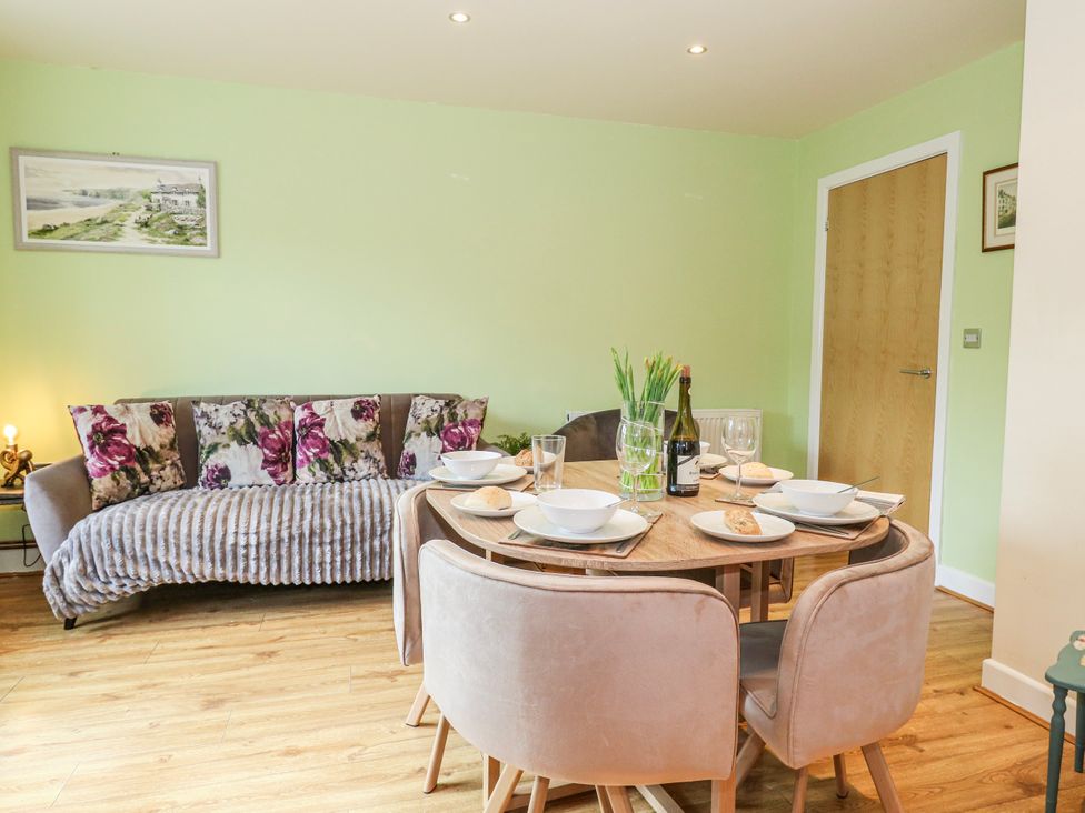 A dining area with a table set for meals at Rodwell Holt in Weymouth