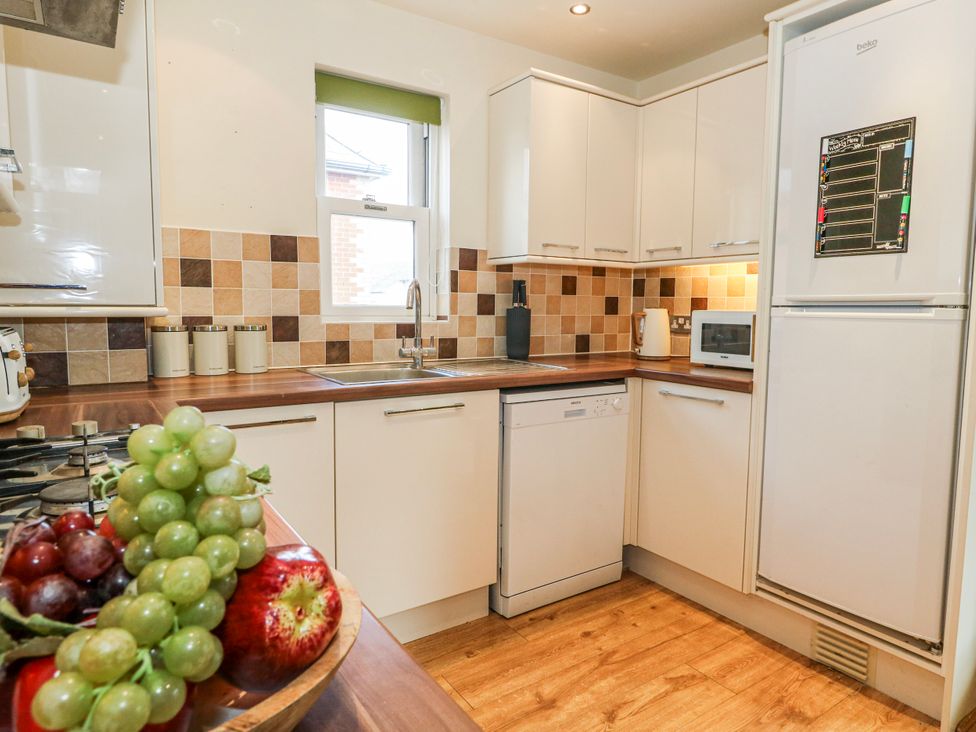 A kitchen with a sink, dishwasher, and fruit bowl at Rodwell Holt in Weymouth