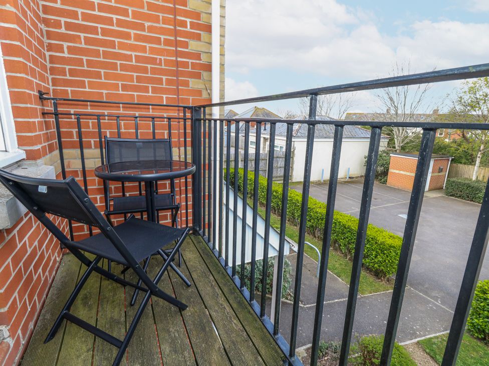 A balcony with a table and chair at Rodwell Holt in Weymouth