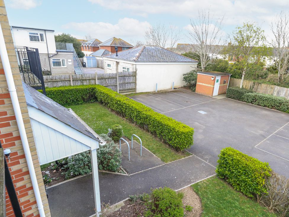 An outdoor area with a car park and bushes at Rodwell Holt in Weymouth