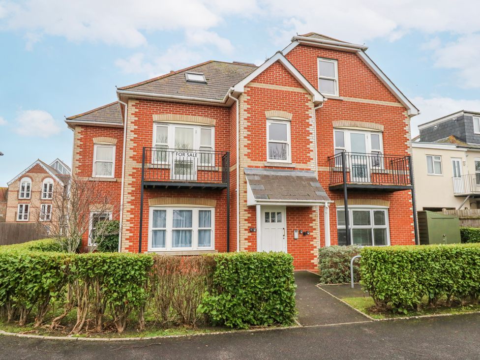 A house with a front door and balcony at Rodwell Holt in Weymouth