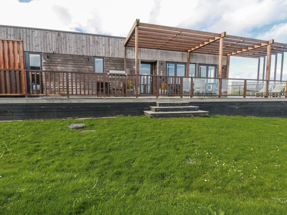 An outdoor area with wooden decking and a pergola at Adelaide in Redruth