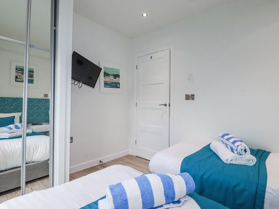 A bedroom with beds and towels at Adelaide in Redruth