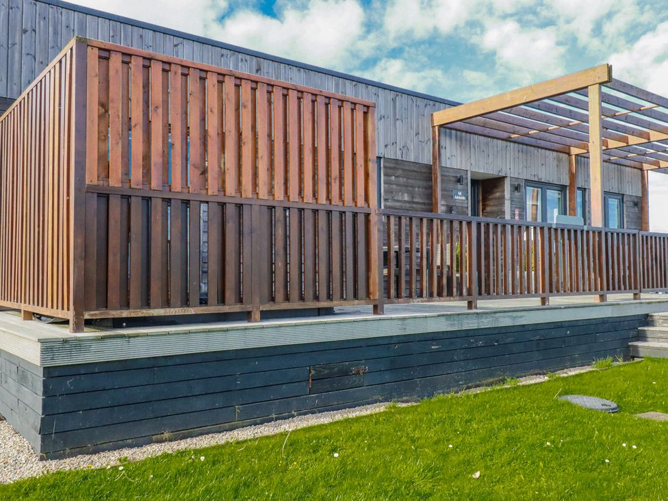 An outdoor area with decking and a wooden fence at Adelaide in Redruth