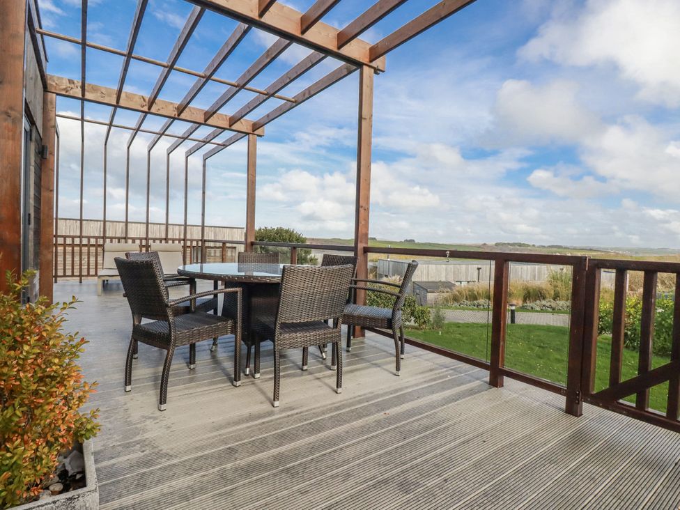 An outdoor seating area with a table and chairs at Adelaide in Redruth