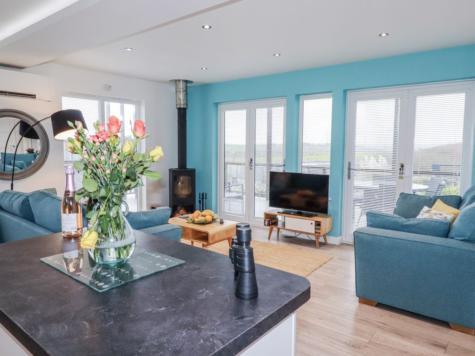 A living room with a sofa and television at Adelaide in Portreath