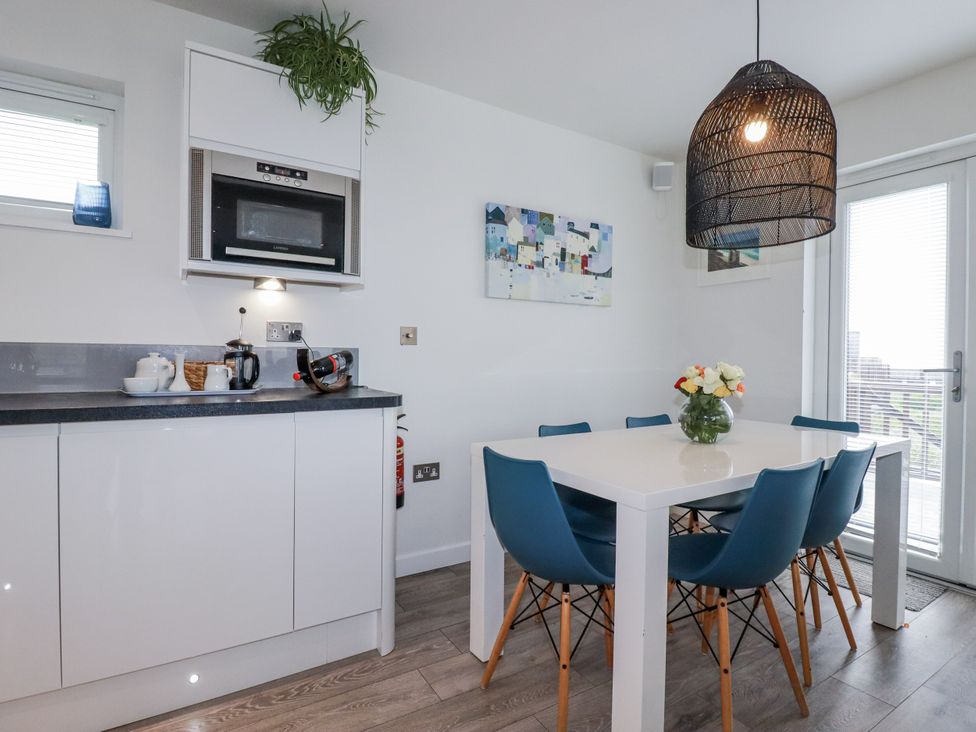 A kitchen with a dining table and chairs at Adelaide in Portreath