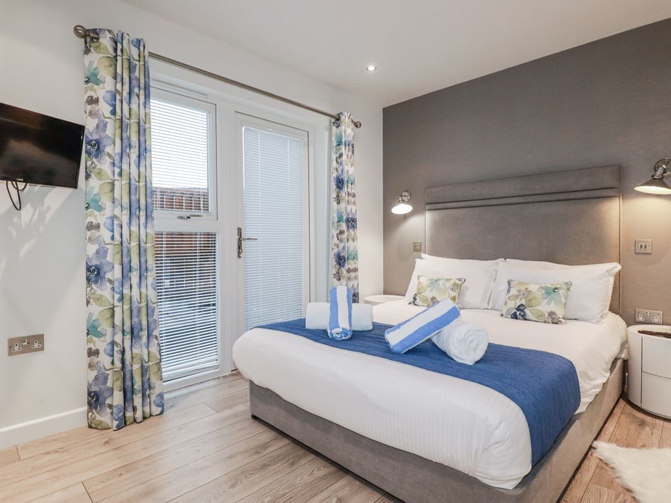 A bedroom with a bed and a television at Adelaide in Portreath