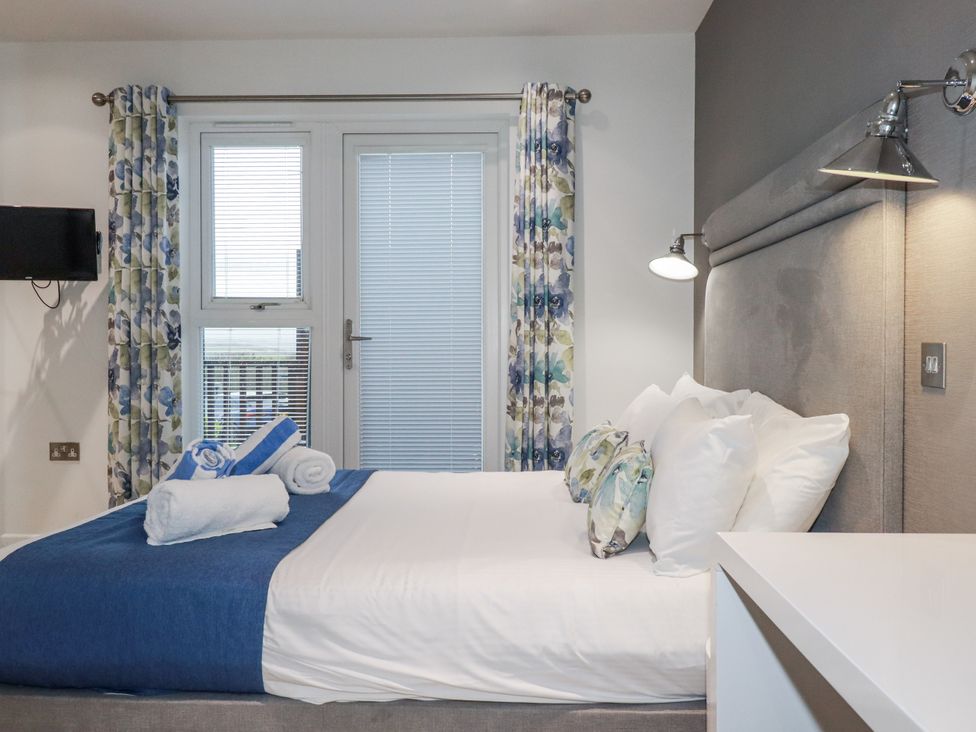 A bedroom with a bed and window at Adelaide in Portreath