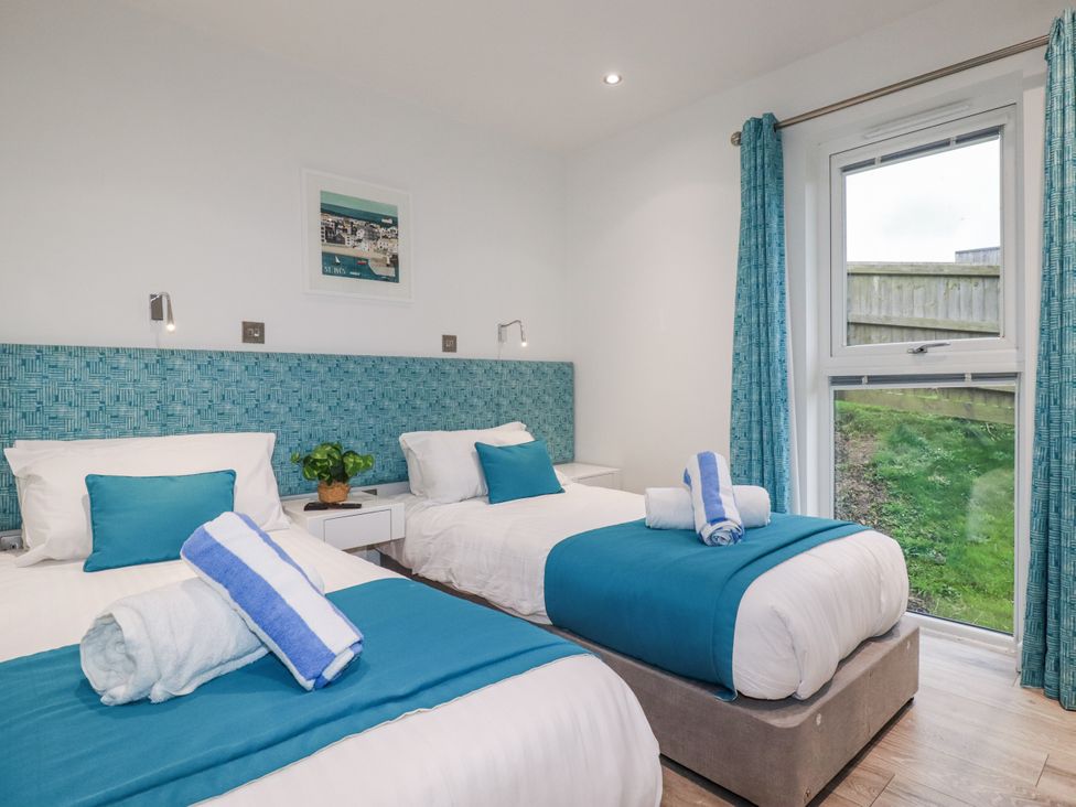 A bedroom with two beds and a window at Adelaide in Portreath