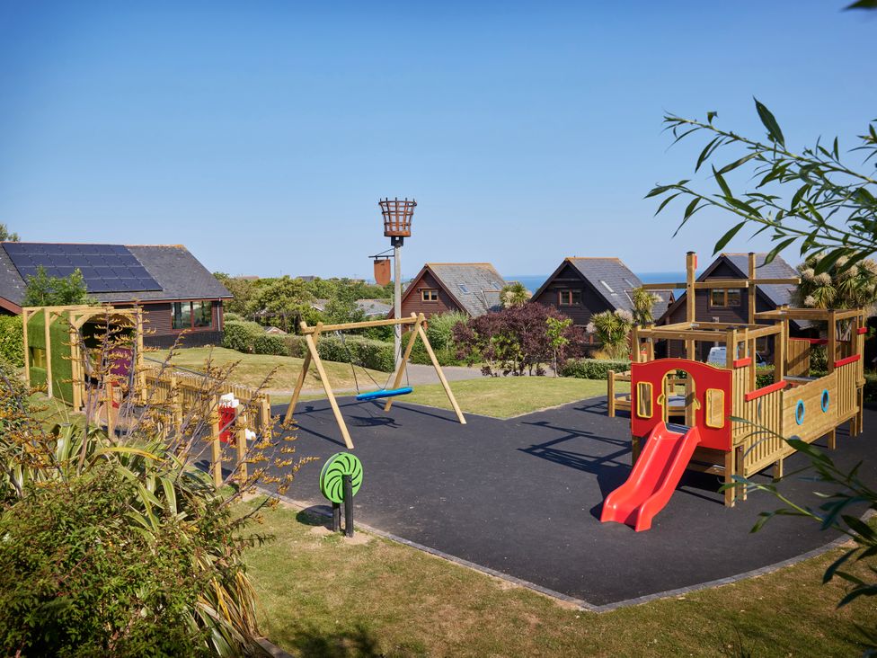 A playground with swings and slide in an outdoor area at Adelaide in Portreath