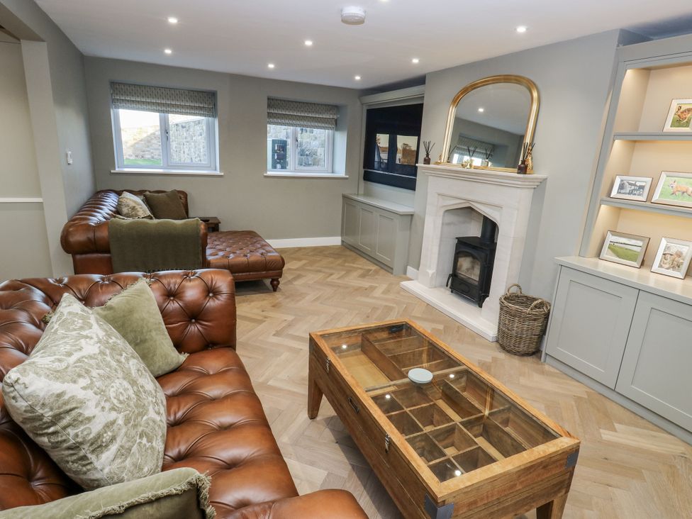 A living room with a fireplace and sofa at The Robins Nest