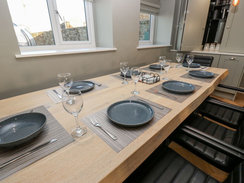 A dining table set with plates and glasses at The Robins Nest