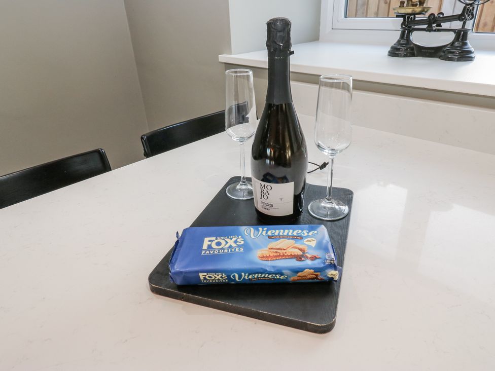 A kitchen counter with champagne and cookies at The Robins Nest 