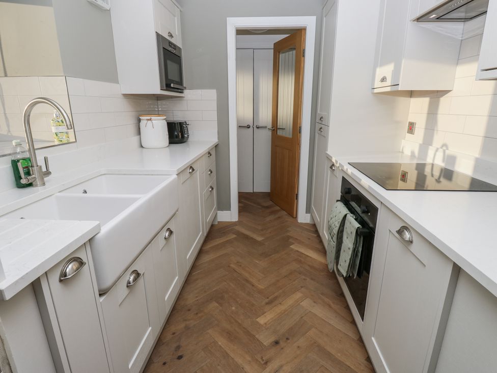 A kitchen with cabinets and appliances at The Robins Nest 