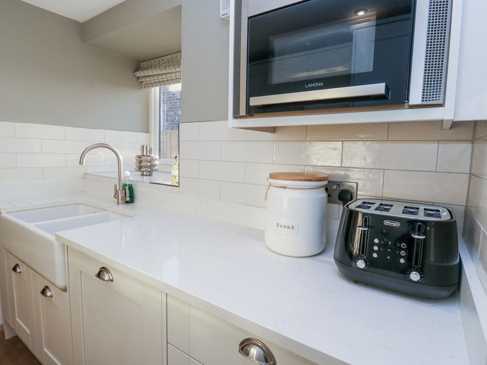 A kitchen with a sink and appliances at The Robins Nest 