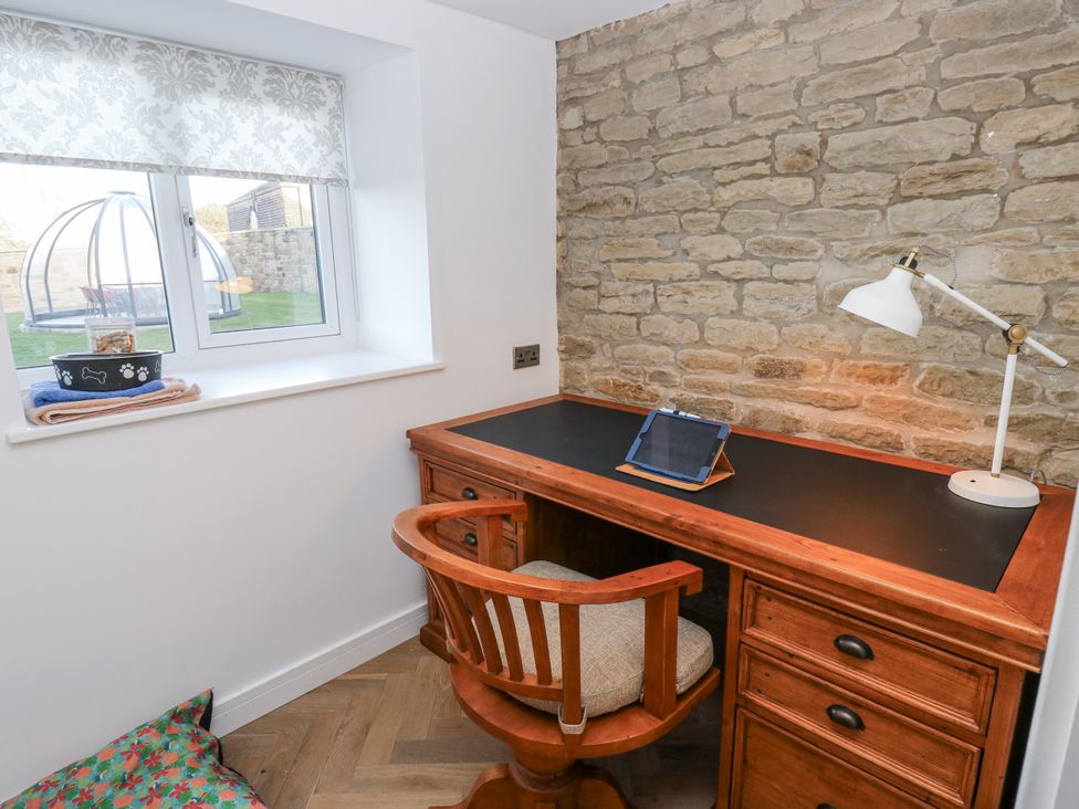 A home office with a desk and chair at The Robins Nest in 