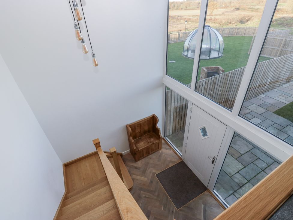 An entrance area with a staircase and a door at The Robins Nest 