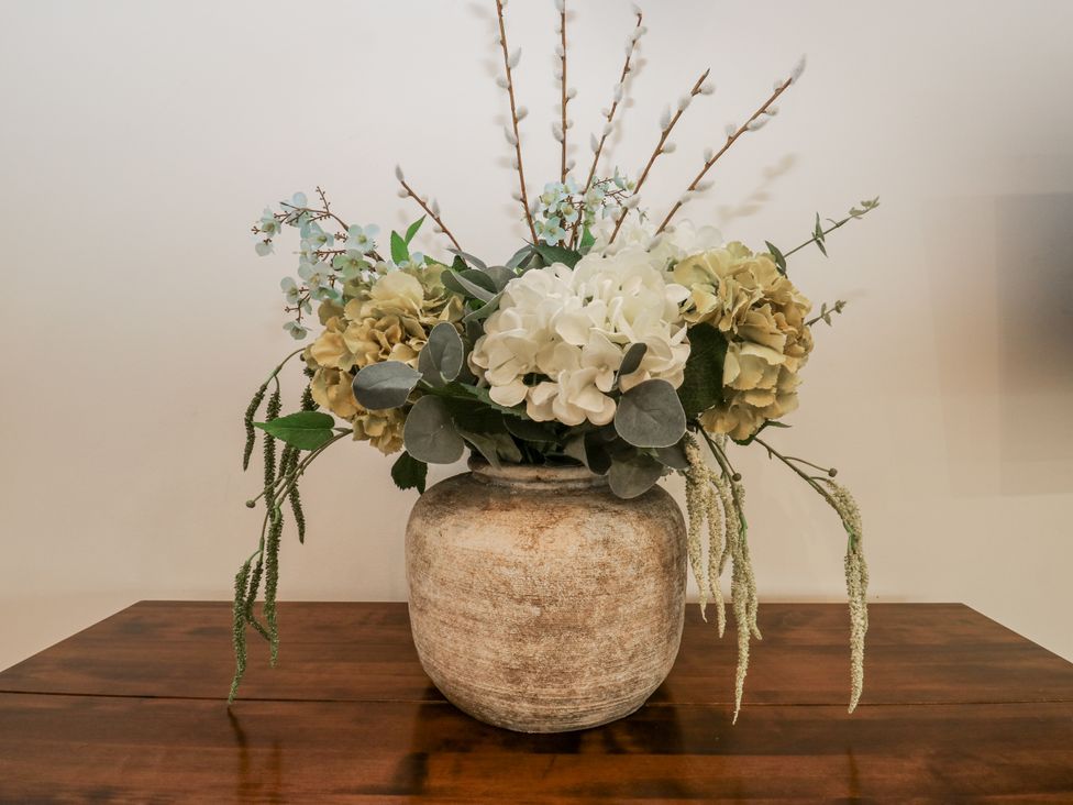 A flower arrangement in a vase on a table at The Robins Nest