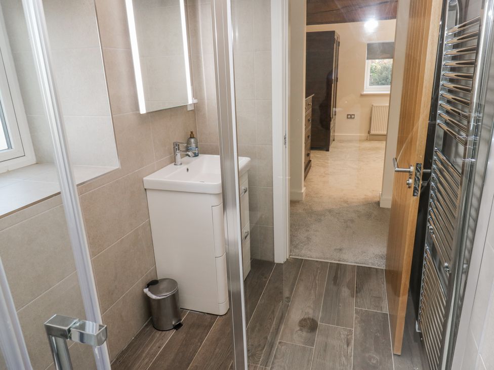 A bathroom with a sink and shower at The Robins Nest 