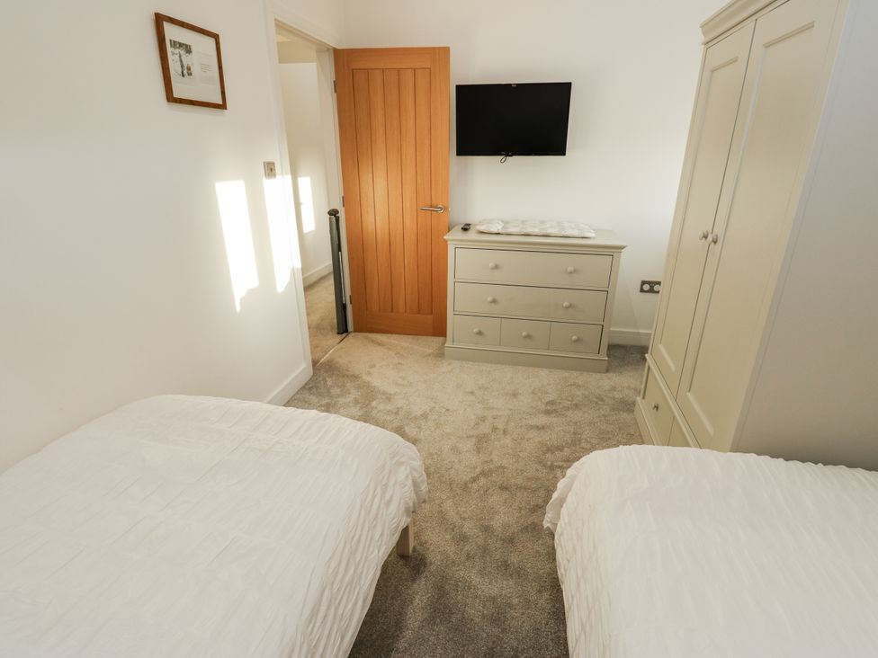 A bedroom with two beds and a dresser at The Robins Nest