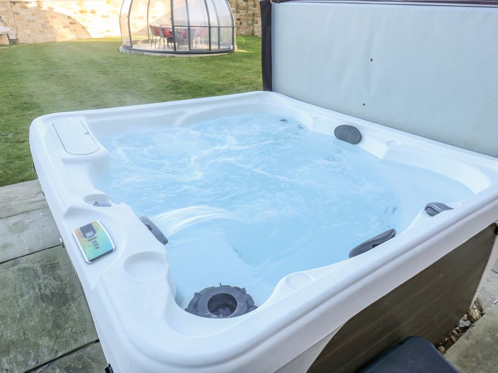 A hot tub with water and temperature control in an outdoor area at The Robins Nest