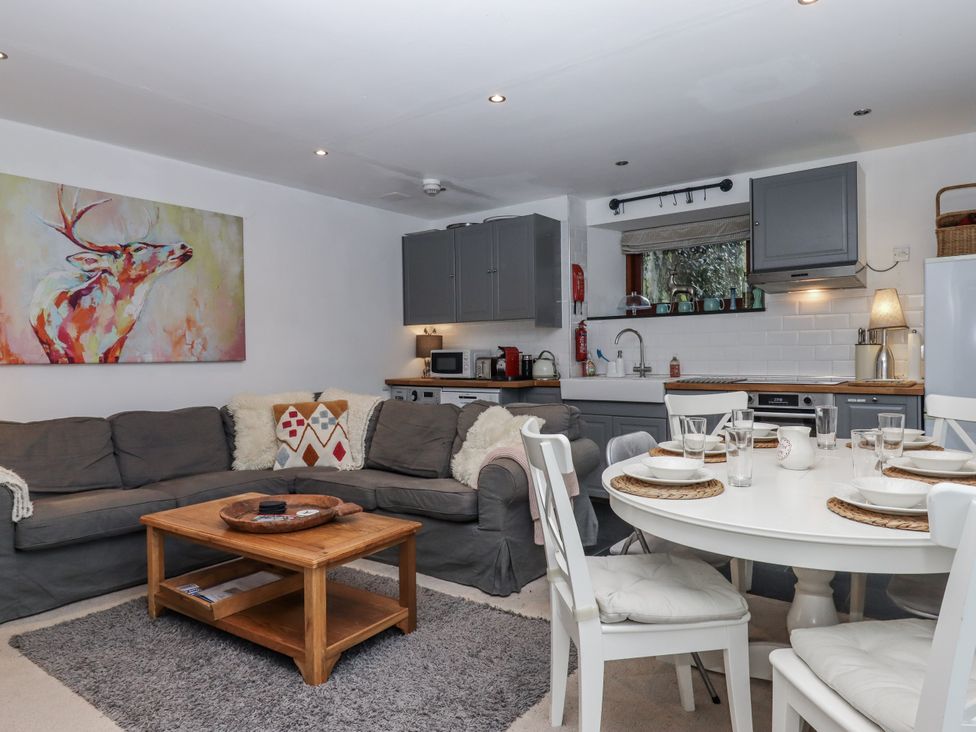 A living room with a sofa and dining area at Clifford Lodge Barn