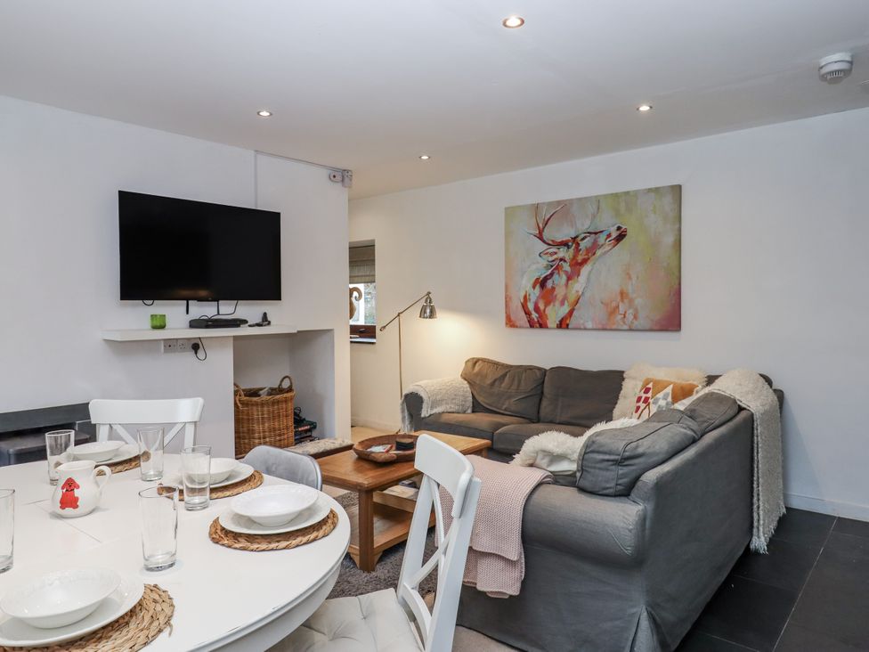 A living room with a sofa and television at Clifford Lodge Barn in 