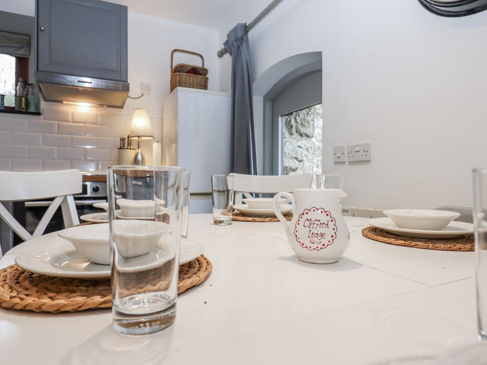A kitchen with a dining table set at Clifford Lodge Barn
