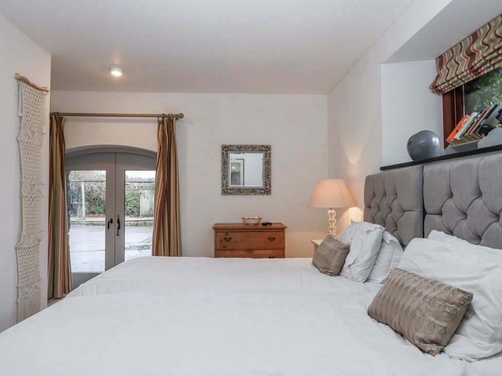 A bedroom with two beds and a window at Clifford Lodge Barn