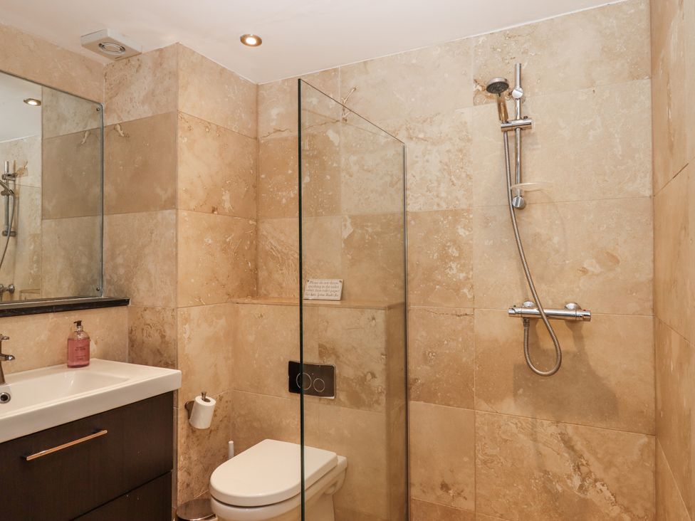 A bathroom with a shower, toilet, and sink at Clifford Lodge Barn