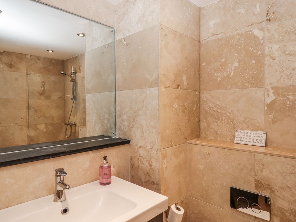 A bathroom with a sink and shower at Clifford Lodge Barn