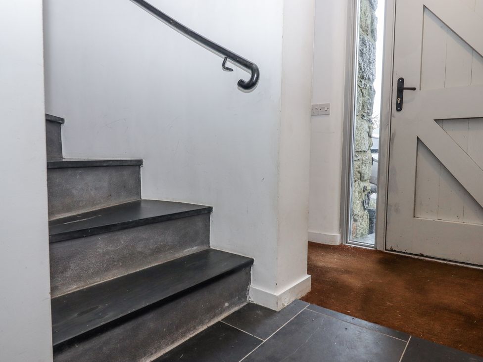 A staircase with a handrail and an open door at Clifford Lodge Barn