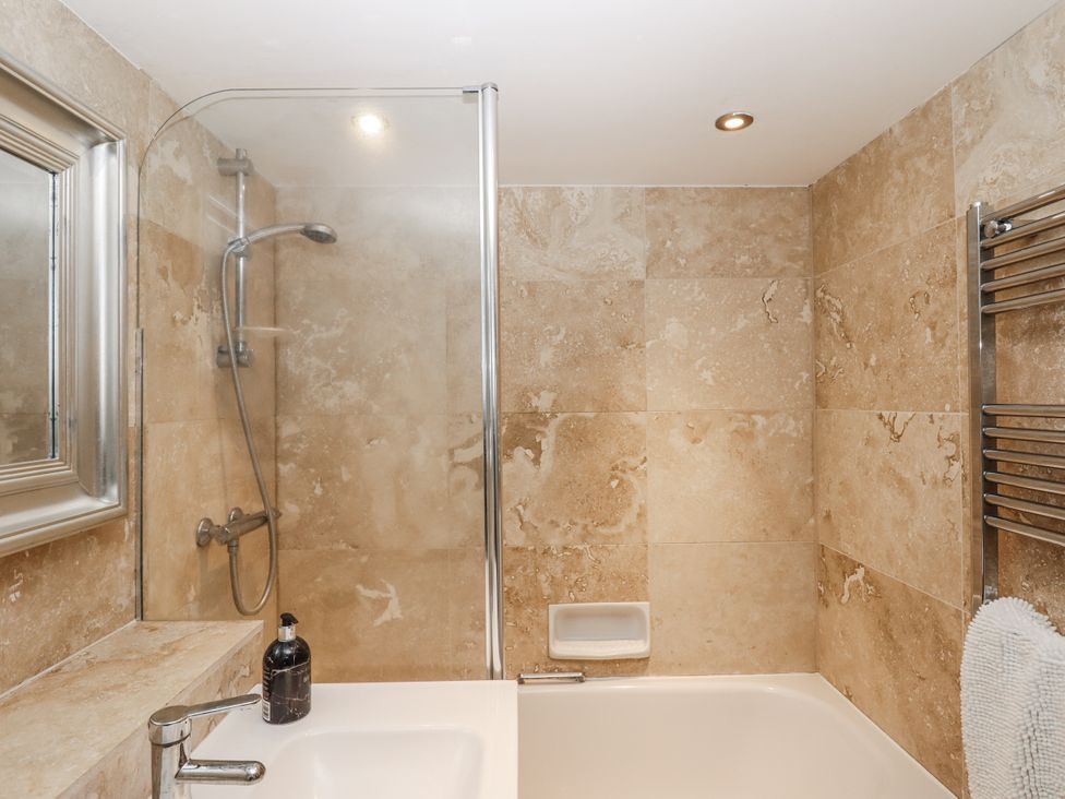 A bathroom with a shower and bathtub at Clifford Lodge Barn