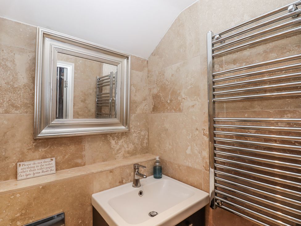A bathroom with a sink and mirror at Clifford Lodge Barn