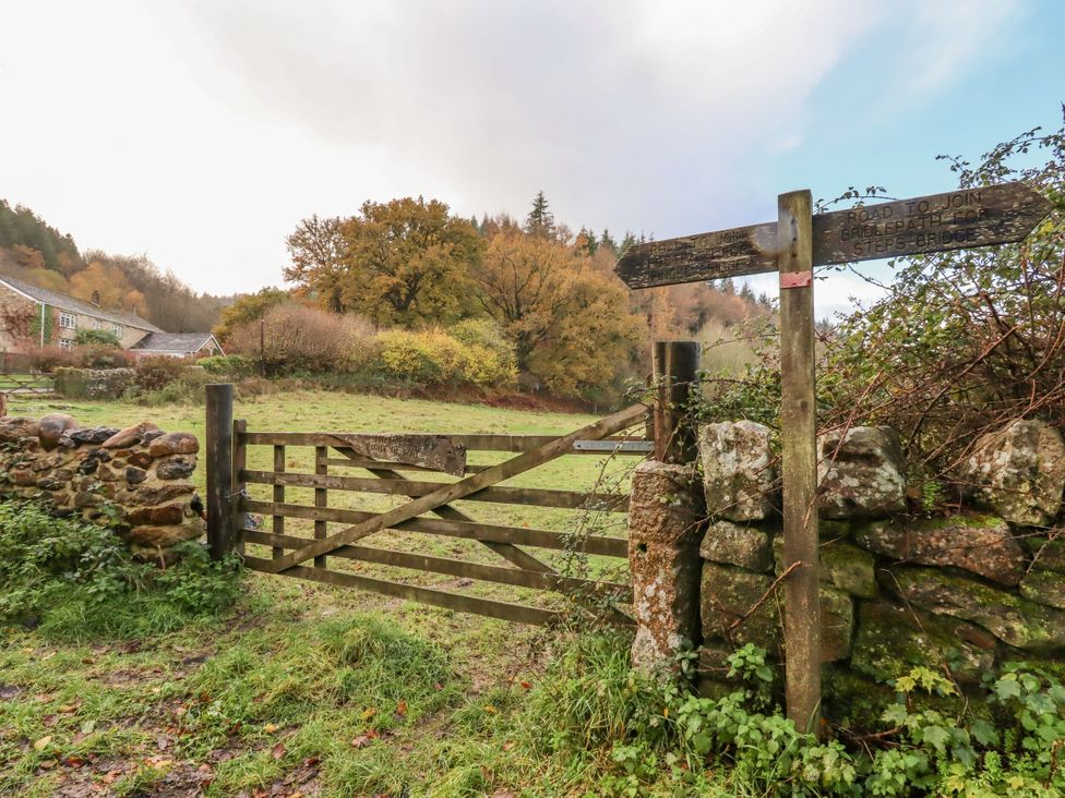 A gate and signpost in a field at Clifford Lodge Barn