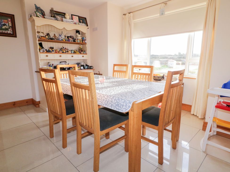 A dining room with a table and chairs at Storey and Half House in Annagry