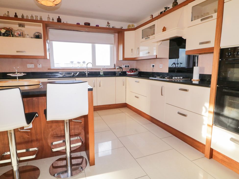 A kitchen with cabinets and appliances at Storey and Half House in Annagry