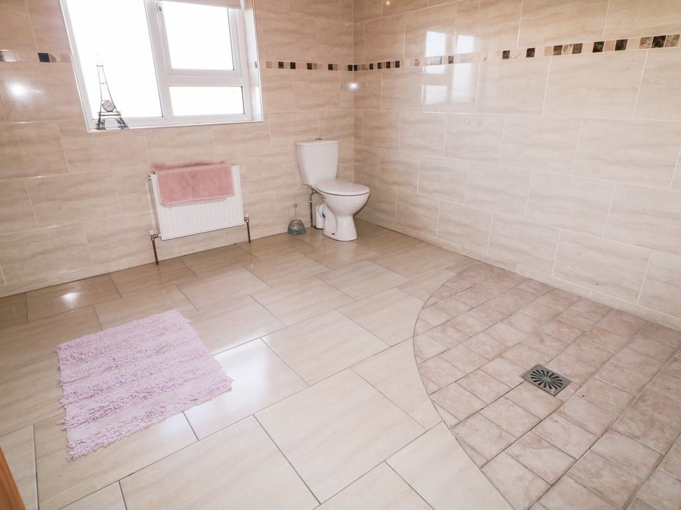 A bathroom with a toilet and towel at Storey and Half House Annagry
