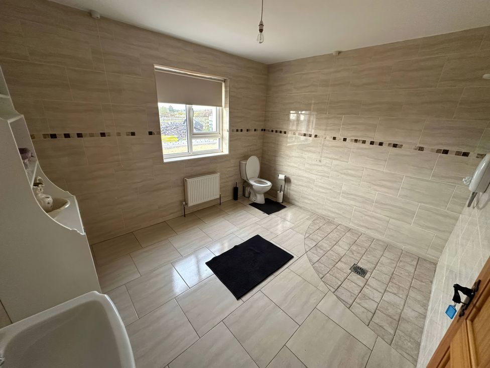 A bathroom with a toilet and sink at Storey and Half House Near Annagry, County Donegal