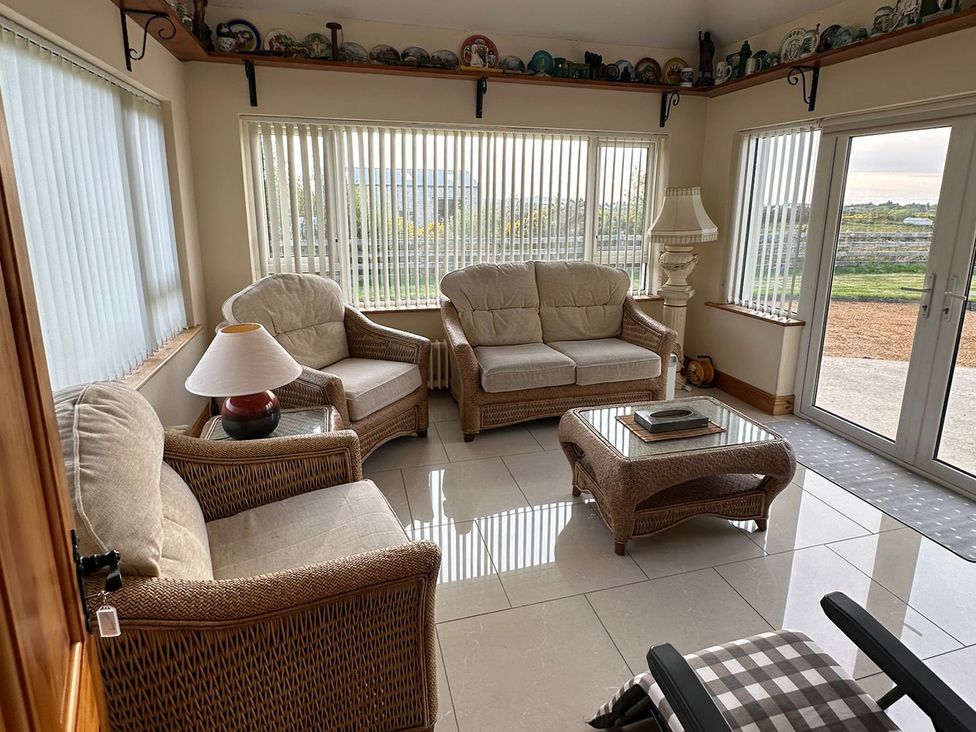 A conservatory with seating area at Storey and Half House Near Annagry, County Donegal