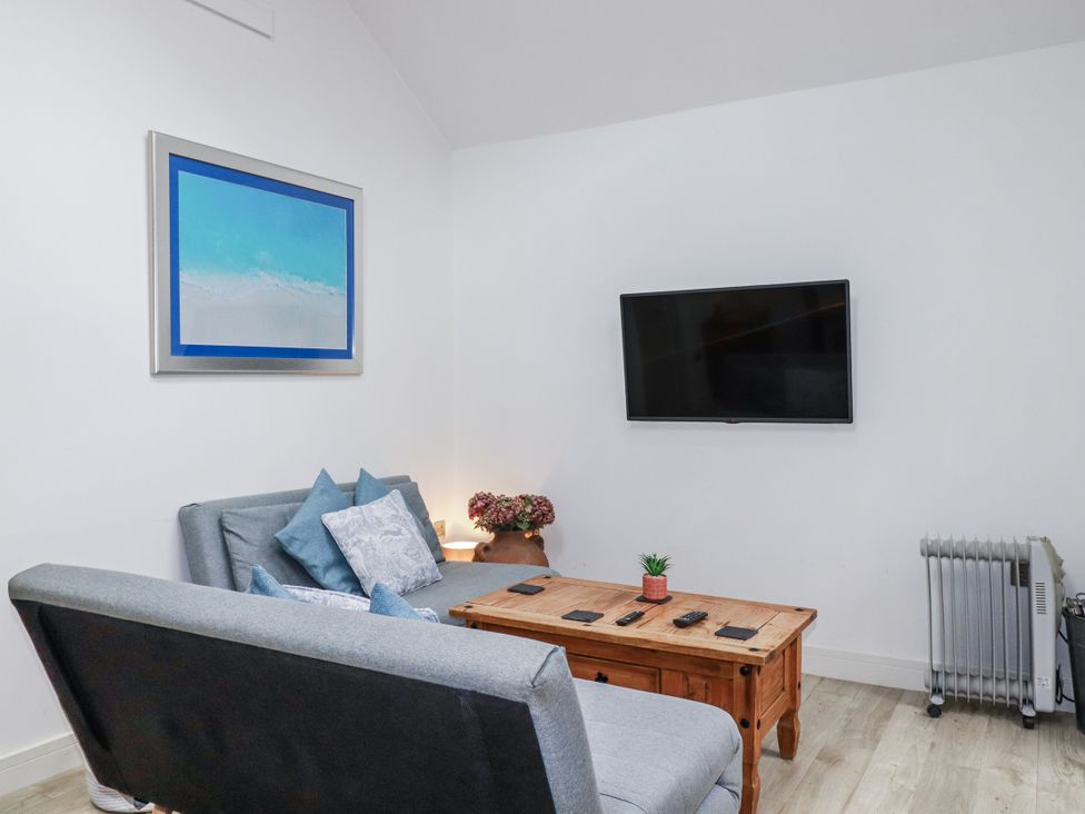 A living room with a sofa and coffee table at Cove Retreat in Penzance
