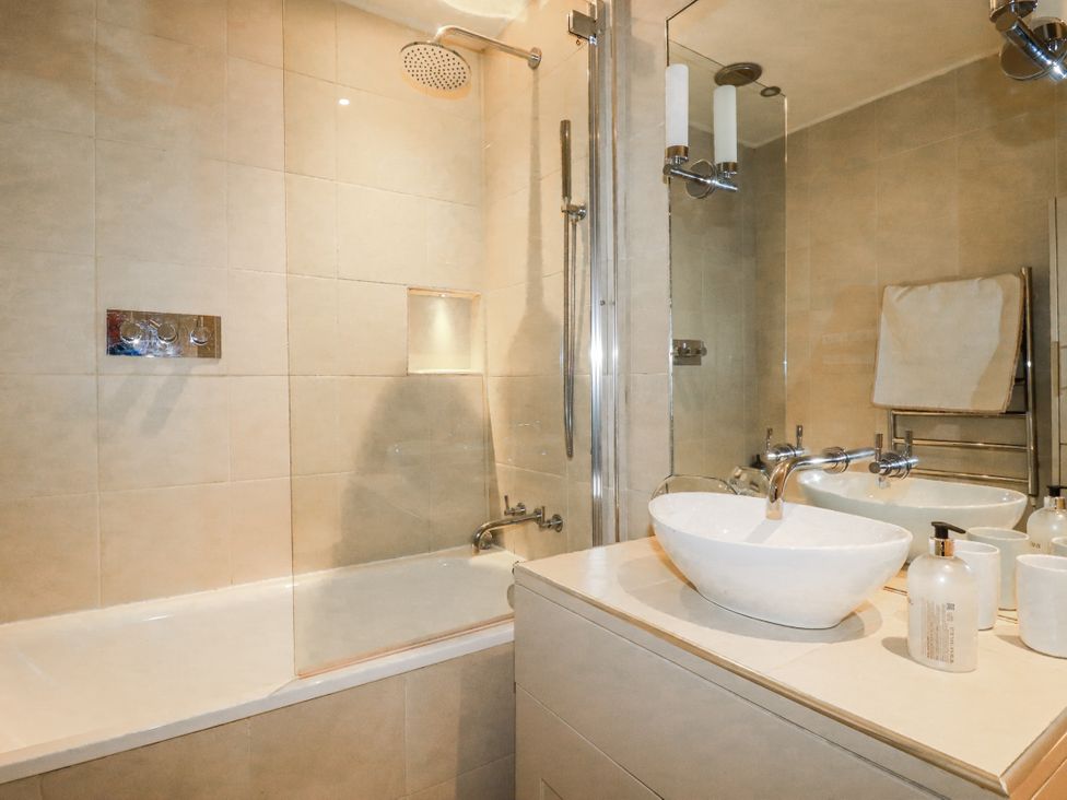 A bathroom with a bathtub and sink at Cove Retreat in Penzance