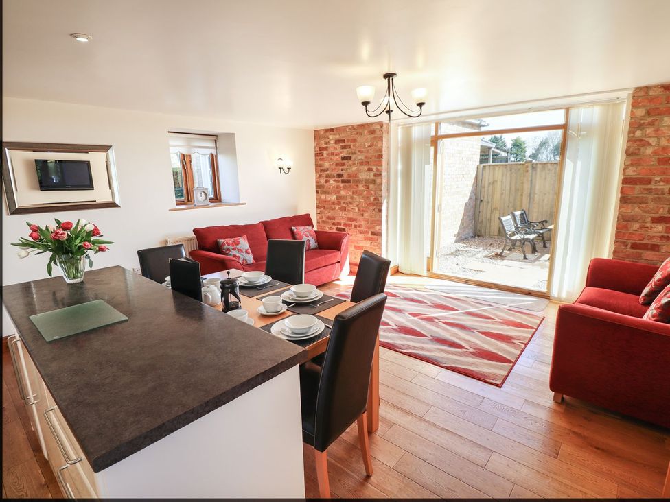 A living room with a dining area and seating at The Granary in Louth