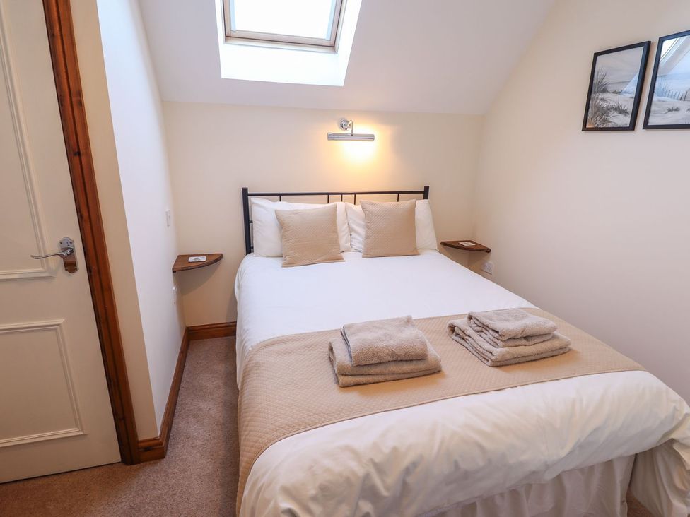 A bedroom with a bed and bedside tables at The Granary in Louth