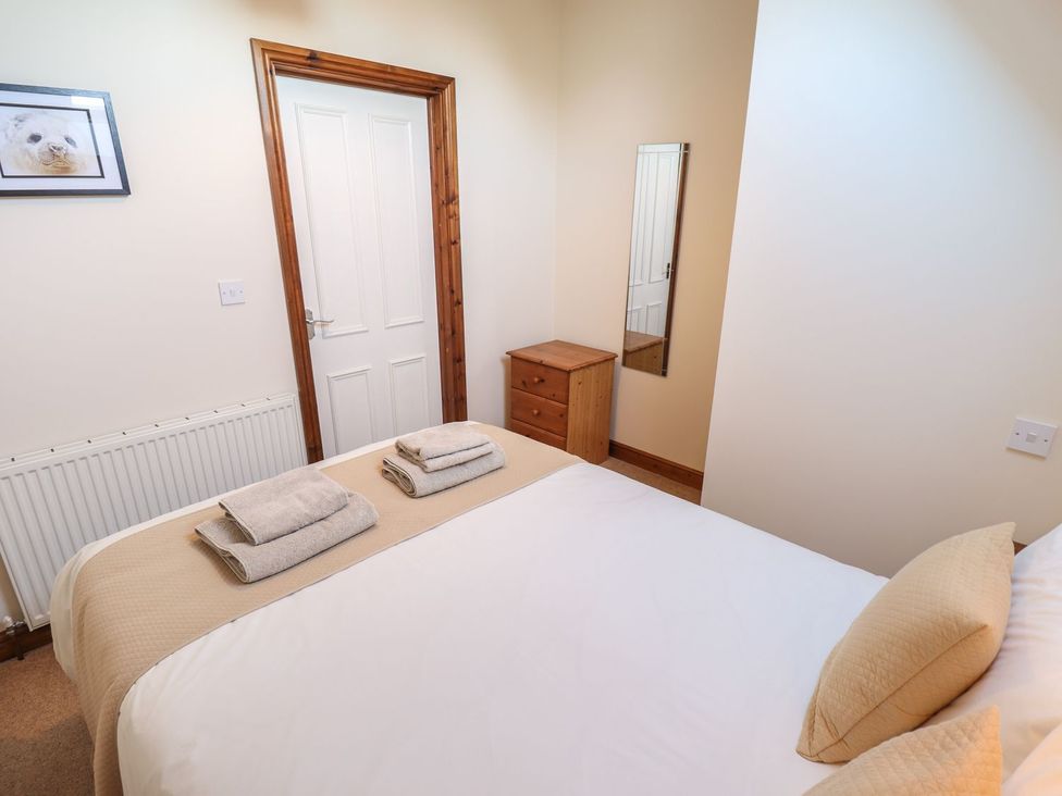 A bedroom with a bed and dresser at The Granary in Louth