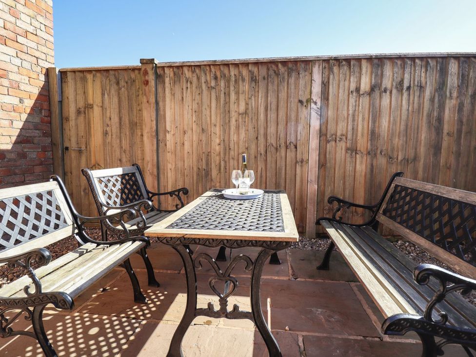 An outdoor seating area with a table and chairs at The Granary in Louth